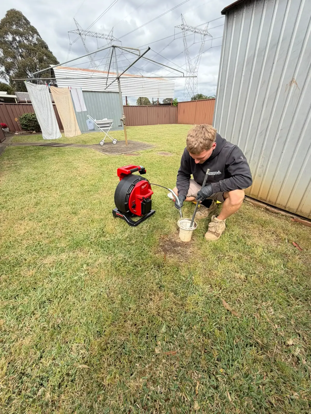 Drain camera equipment being used at a backyard inspection point