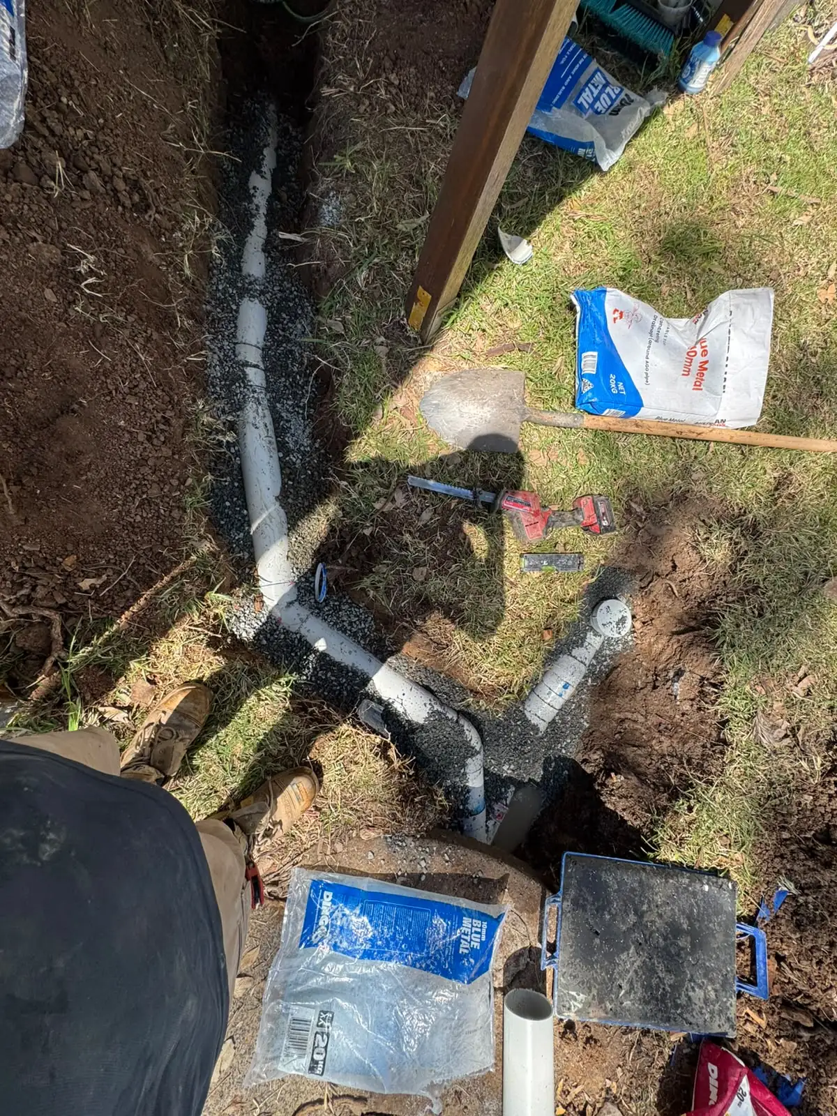New drainage pipework installed in an excavated trench