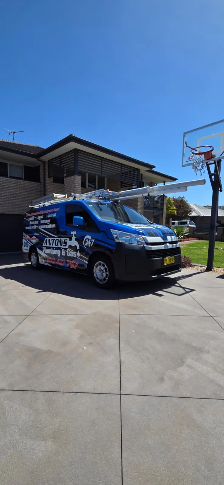 Blue Antons plumbing van parked on a residential driveway