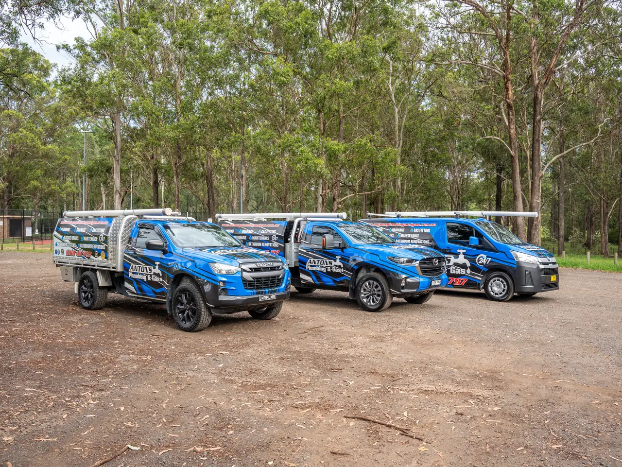 Four blue Antons plumbing service vehicles parked together