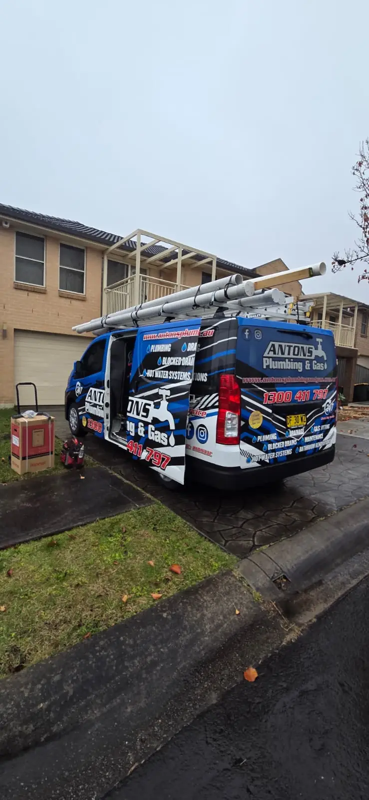 Blue Antons plumbing vehicle outside a residential property